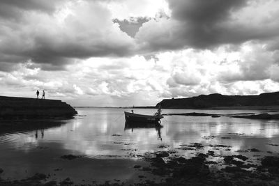 Scenic view of lake against cloudy sky