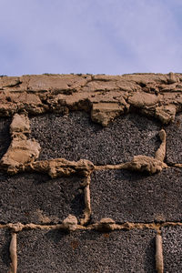 Close-up of rocks on land against sky