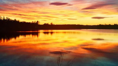 Scenic view of lake against romantic sky at sunset