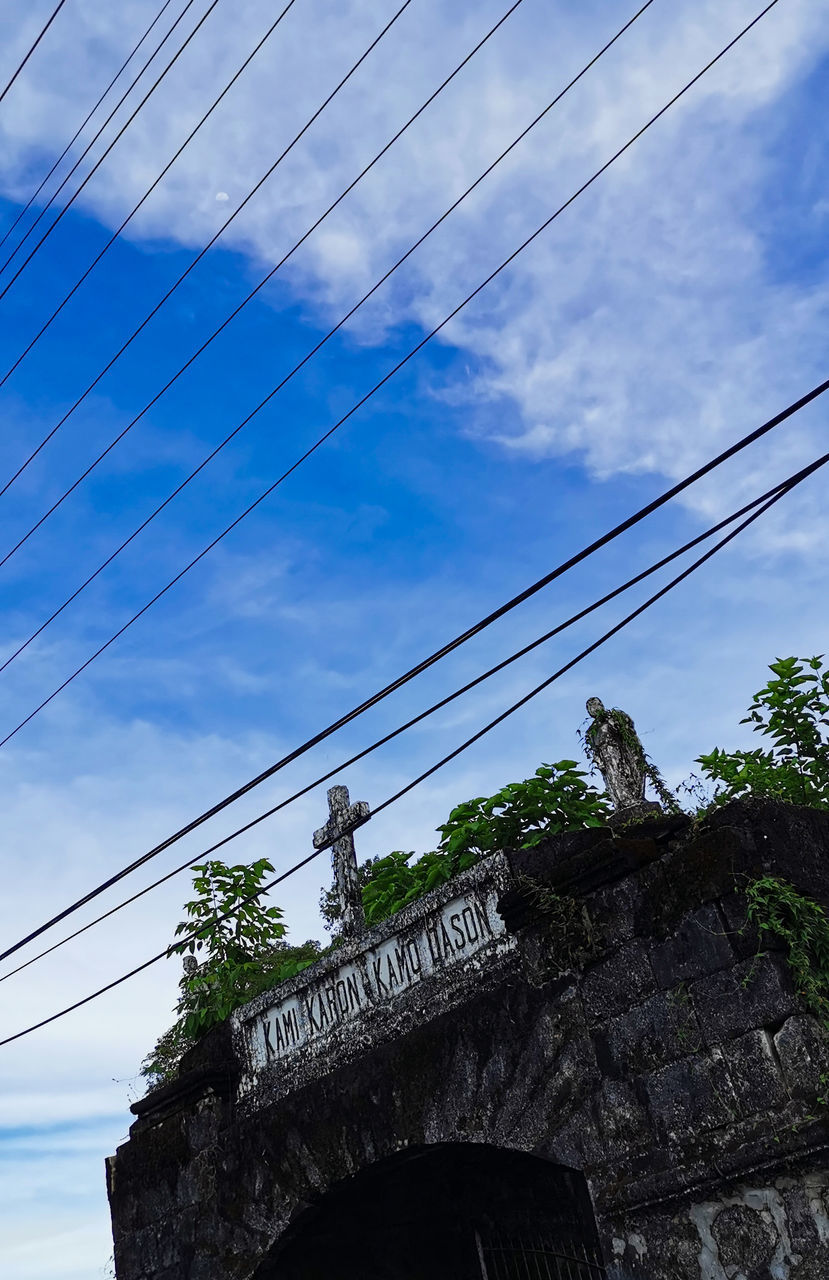 cable, architecture, sky, built structure, cloud, low angle view, electricity, power line, building exterior, nature, blue, no people, technology, day, power supply, city, outdoors, history, building, the past, travel destinations, communication, electricity pylon, tower, urban area