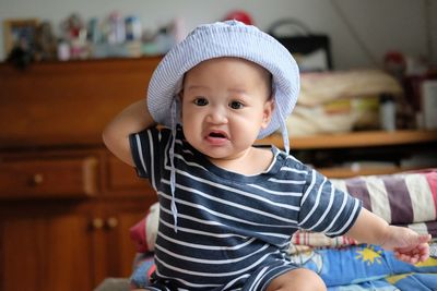 Portrait of cute girl sitting at home