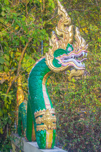 Statue of buddha against plants