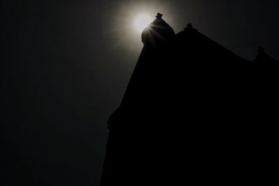 Low angle view of silhouette statue against sky at night