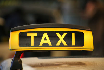 Close-up of yellow sign on street