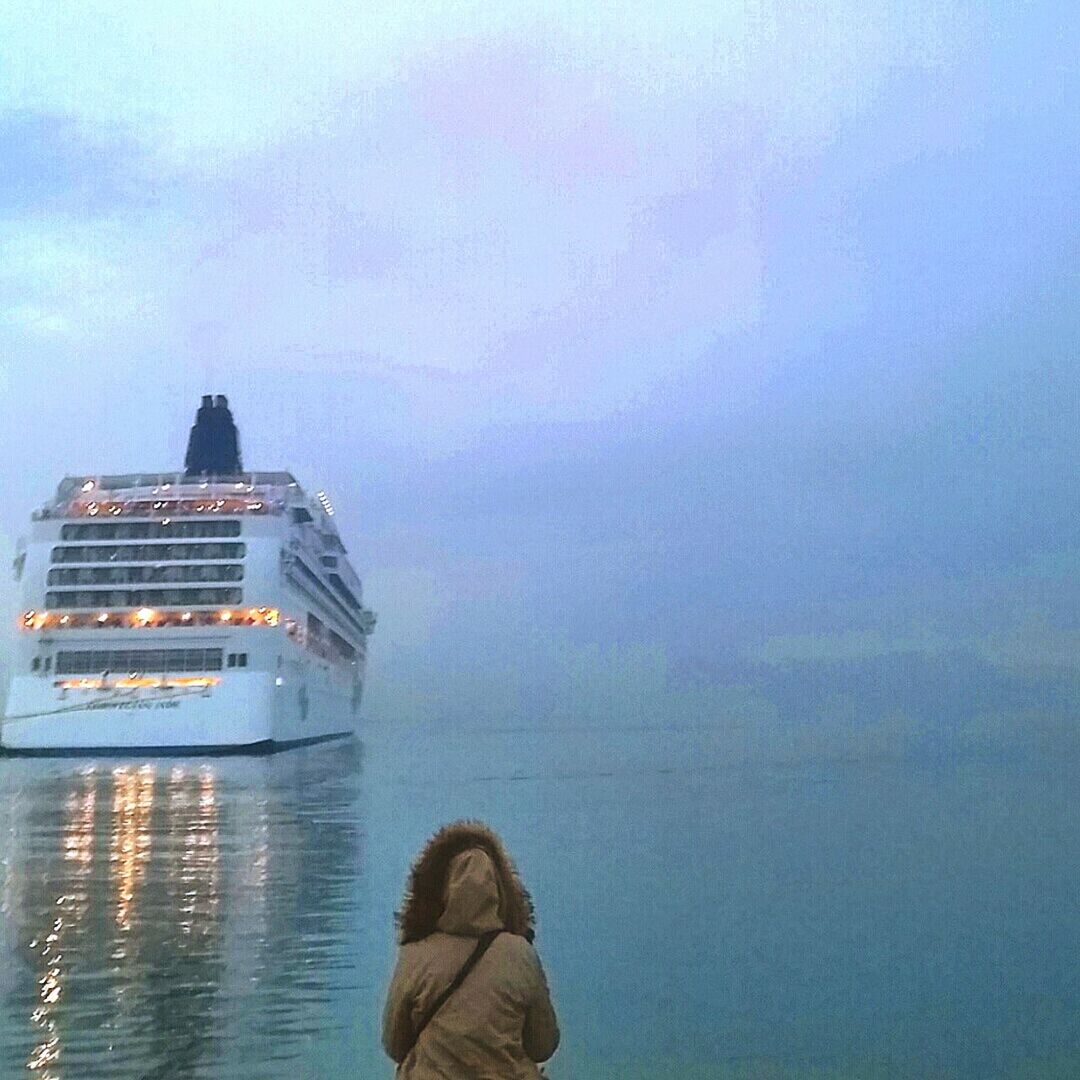 water, sky, lifestyles, leisure activity, sea, men, rear view, standing, waterfront, cloud - sky, waist up, horizon over water, reflection, unrecognizable person, outdoors, tranquility, nature, scenics