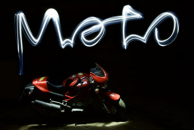 Close-up of illuminated lighting equipment against black background