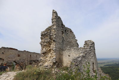 Low angle view of old ruins against sky