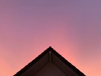 Low angle view of silhouette building against sky during sunset