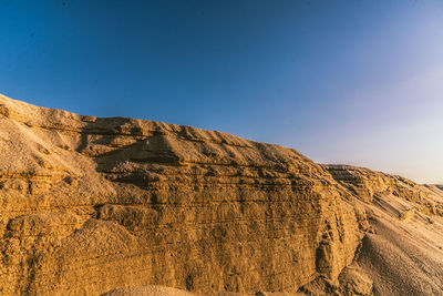 Scenic view of rocky mountains against clear blue sky