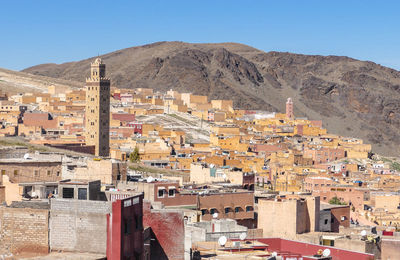 Buildings in town against clear sky