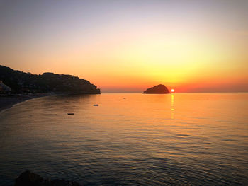 Scenic view of sea against clear sky during sunset