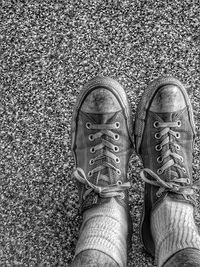 Low section of man standing on tiled floor