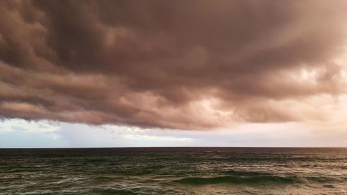 Scenic view of sea against dramatic sky