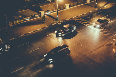 High angle view of illuminated cars on road at night