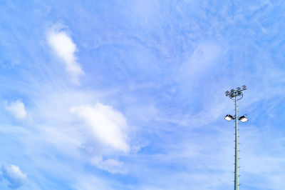 Low angle view of power lines against blue sky