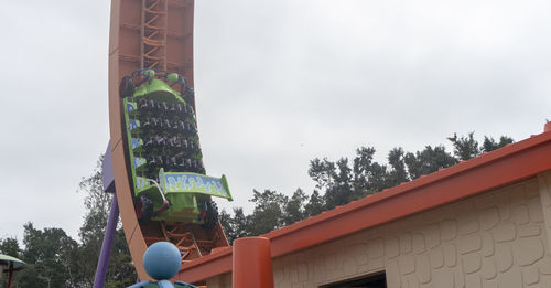 Low angle view of text on building against sky