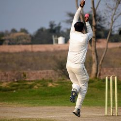 Rear view of man playing on field