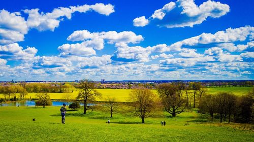 Scenic view of grassy field against cloudy sky