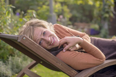 Portrait of smiling young woman sitting on seat