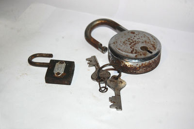 High angle view of padlocks on rusty metal