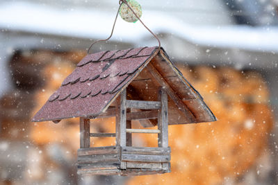 Close-up of wet birdhouse during winter