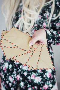 Cropped image of woman giving gift box to friend during christmas