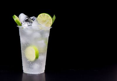 Close-up of beer glass against black background