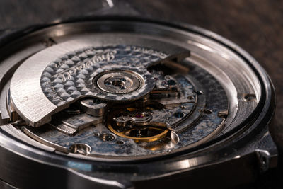 High angle view of damaged watch on table