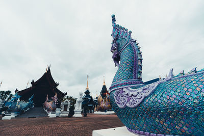 Low angle view of temple against cloudy sky