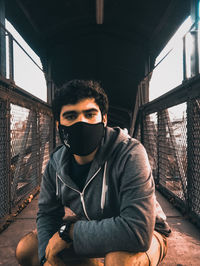 Portrait of young man sitting outdoors