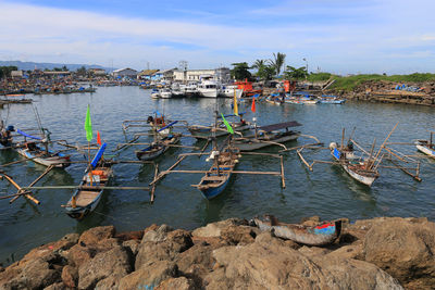 Boats moored on sea against sky