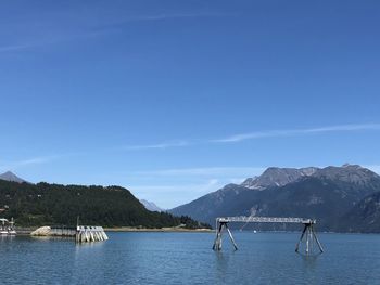 Sailboats in lake against sky