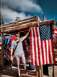 Low angle view of flags hanging against built structure