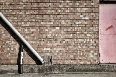 Pipe against brick wall