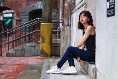 Portrait of young woman sitting outdoors