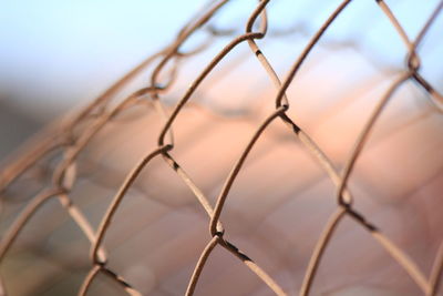 Close-up of chainlink fence against sky