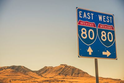 Information sign on desert against clear sky