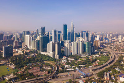 High angle view of road amidst buildings in city against sky