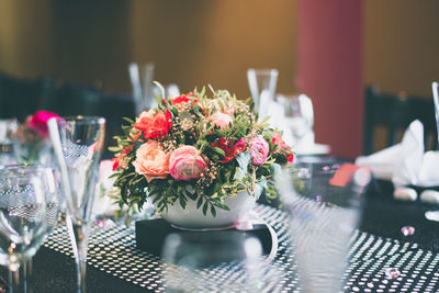 View of glasses and vase on dining table