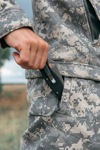 Midsection of man using mobile phone