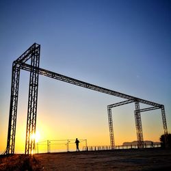 Low angle view of silhouette man standing against clear sky