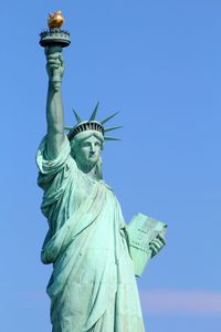 Low angle view of statue against blue sky