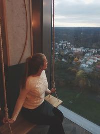 Woman looking through window