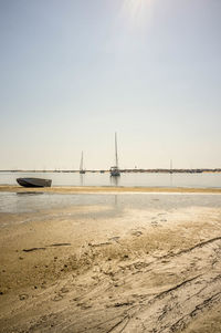 Sailboats on sea against clear sky