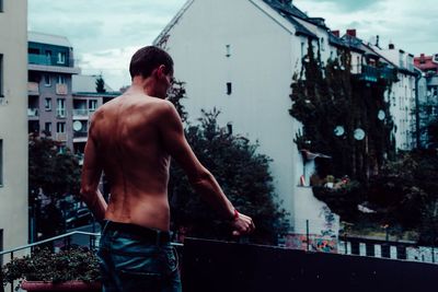 Rear view of shirtless man in water