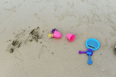 High angle view of pink toy on sand