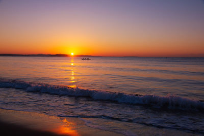 Scenic view of sea against romantic sky at sunset