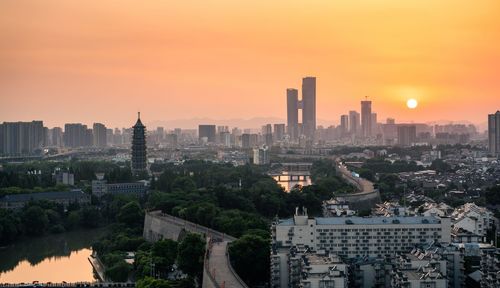 High angle view of buildings against sky during sunset