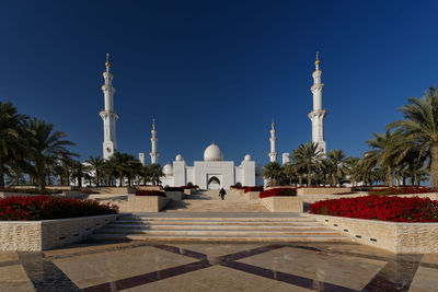 Grand mosque against clear blue sky