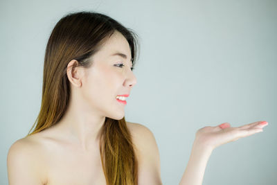 Portrait of a beautiful young woman over white background